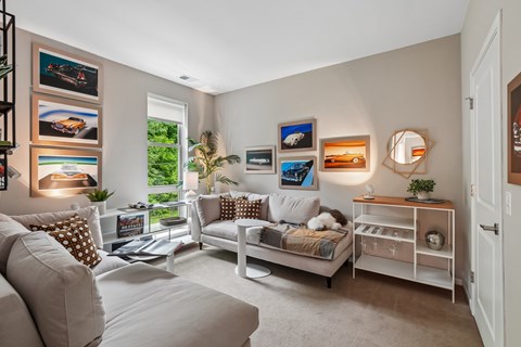 A living room with a white couch and a white chair.