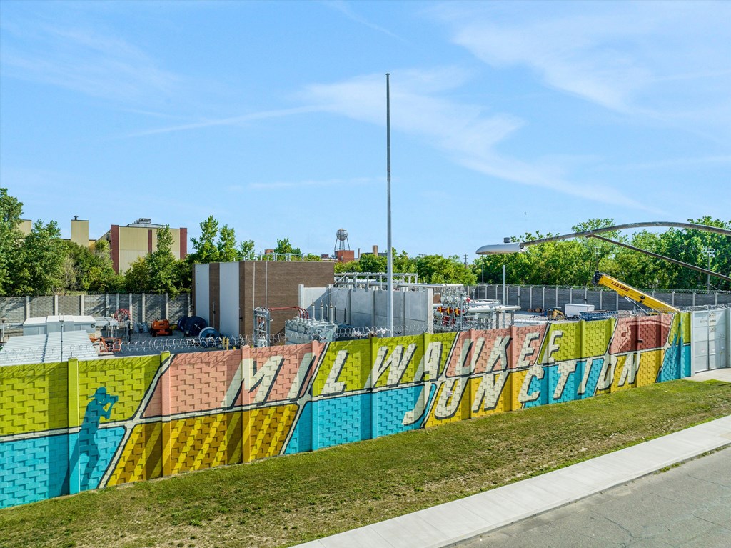 A colorful mural on a fence reads "Walker Juncti".