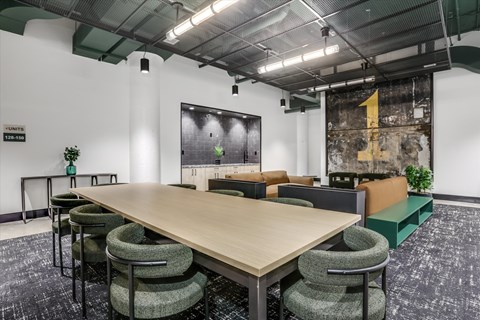 A conference room with a long table and chairs.