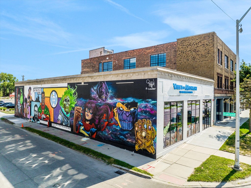 A mural on a building with a white awning that says "Vegan-Friendly".