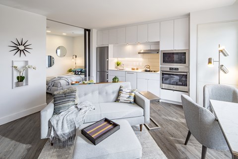 A modern living room with a grey sofa and a coffee table.