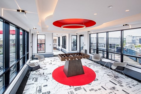 a conference room with a table and chairs and a red rug