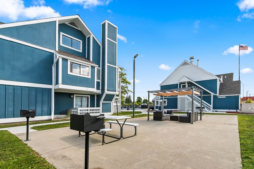 A blue building with a white roof and a flag on top.