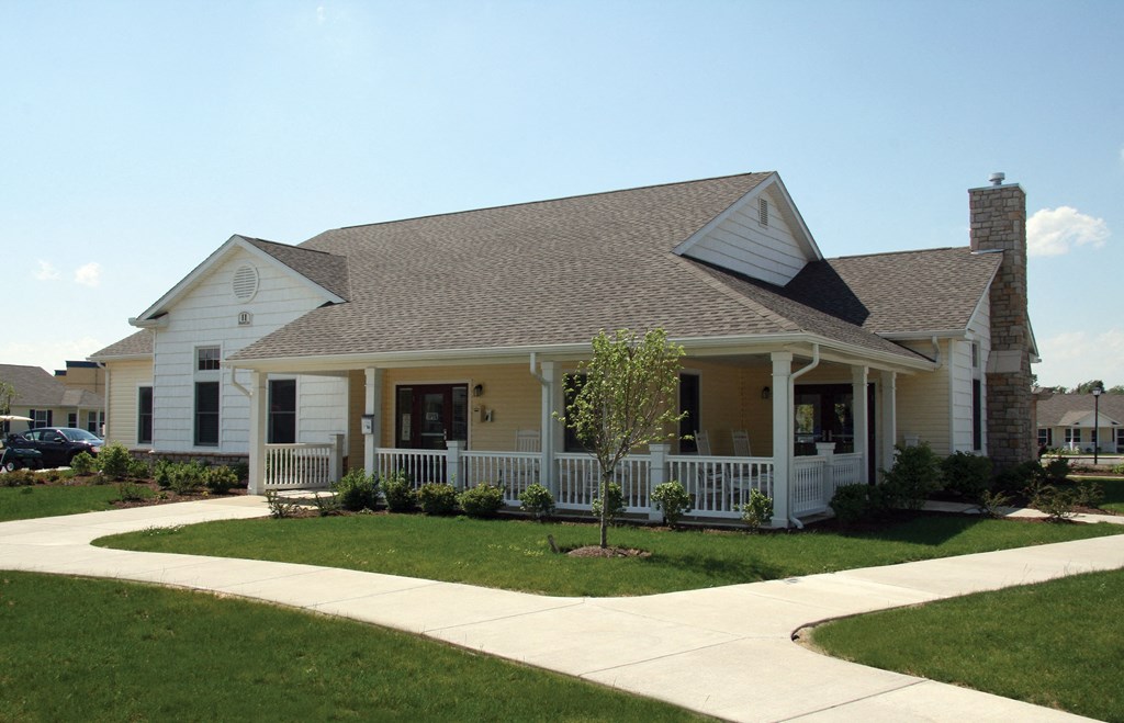 a white house with a porch and a porch swing
