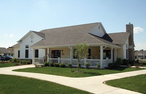 a white house with a porch and a porch swing
