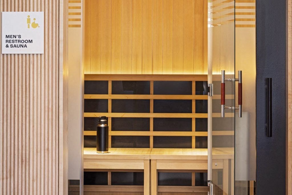 a locker room with a bench and a water bottle in it