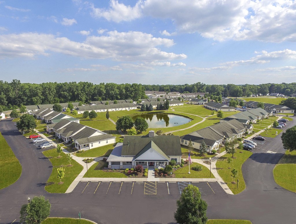 A large, well-maintained residential complex with a central building and multiple houses.