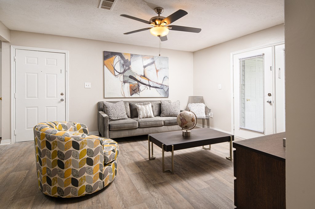 a living room with a ceiling fan and couch