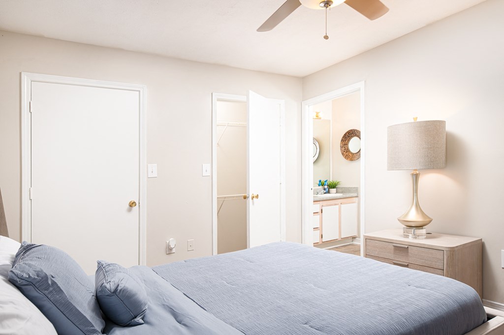 a bedroom with a bed and a ceiling fan