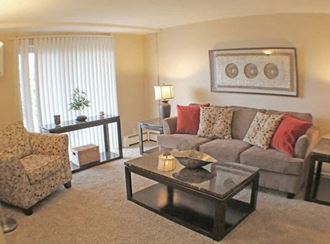 a living room with a couch chair and coffee table