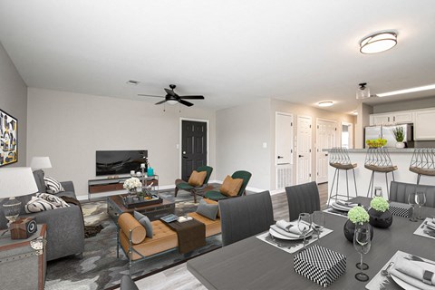 A modern living room with a grey sofa set and a black and white checkered ottoman.
