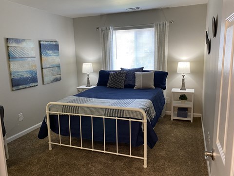 a bedroom with a bed and a window