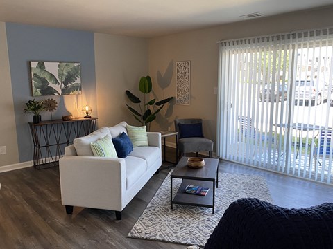 A living room with a white couch and a coffee table.