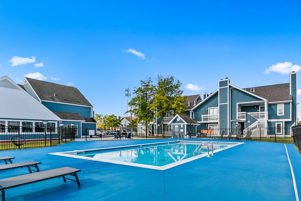 A blue swimming pool in front of a building.