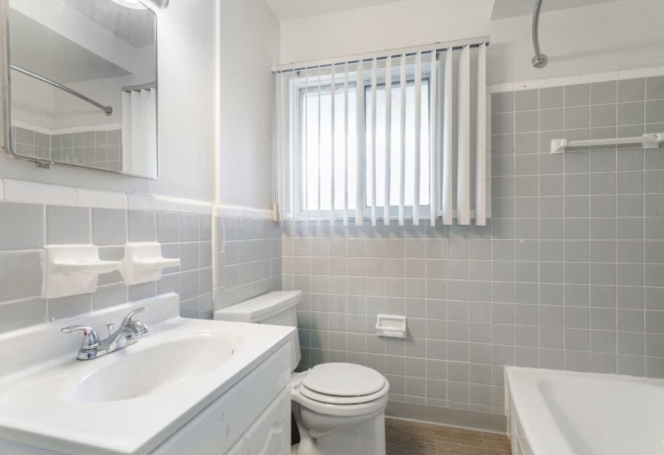 a white bathroom with a sink and a toilet