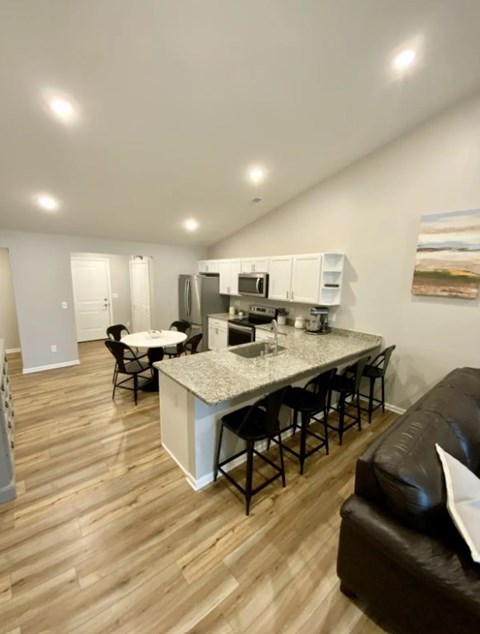 A kitchen with a bar and a couch.