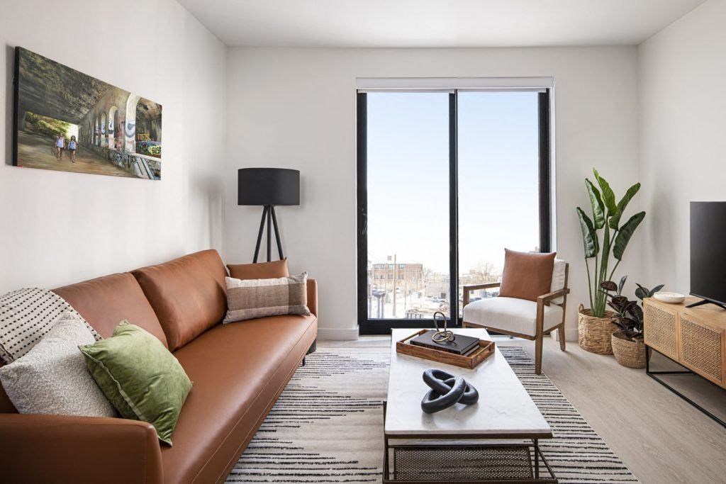 a living room with a brown couch and a coffee table