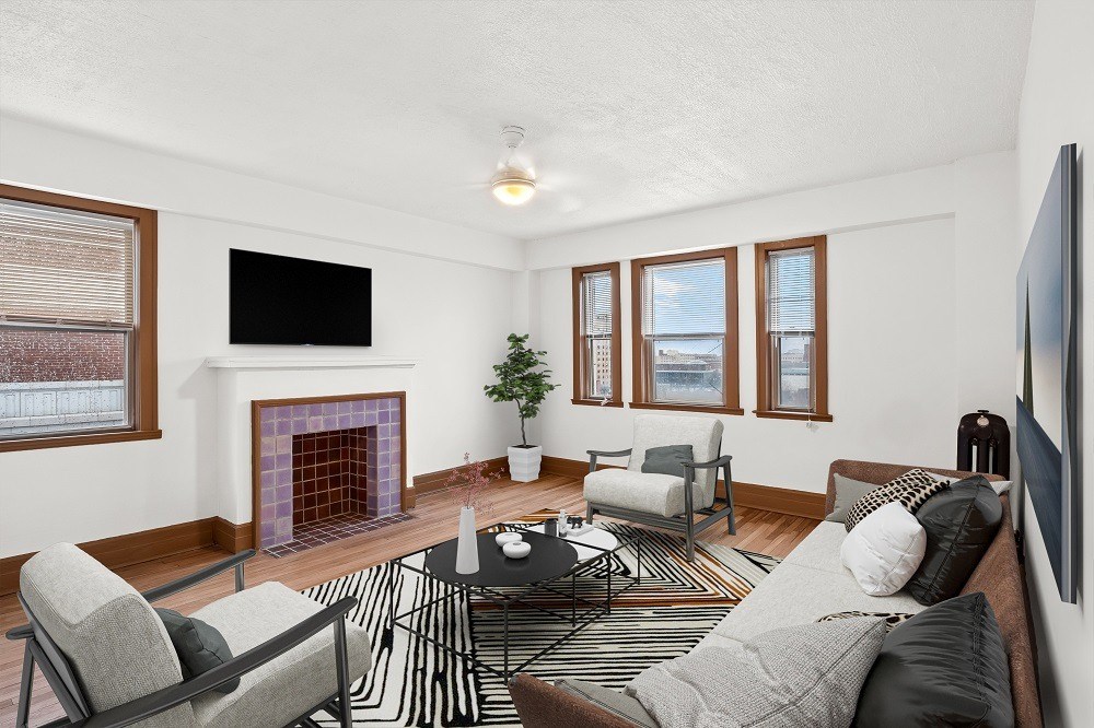 A living room with a fireplace and a television.