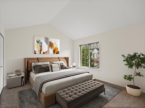 A bedroom with a large bed and a potted plant.