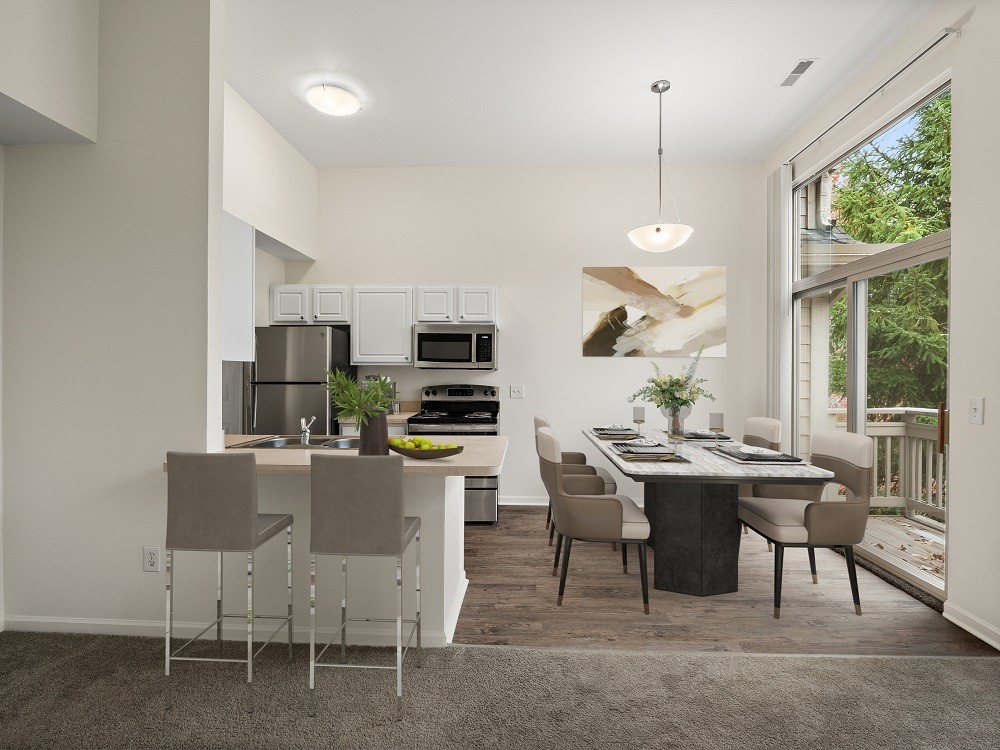 A modern kitchen with a dining table and chairs.