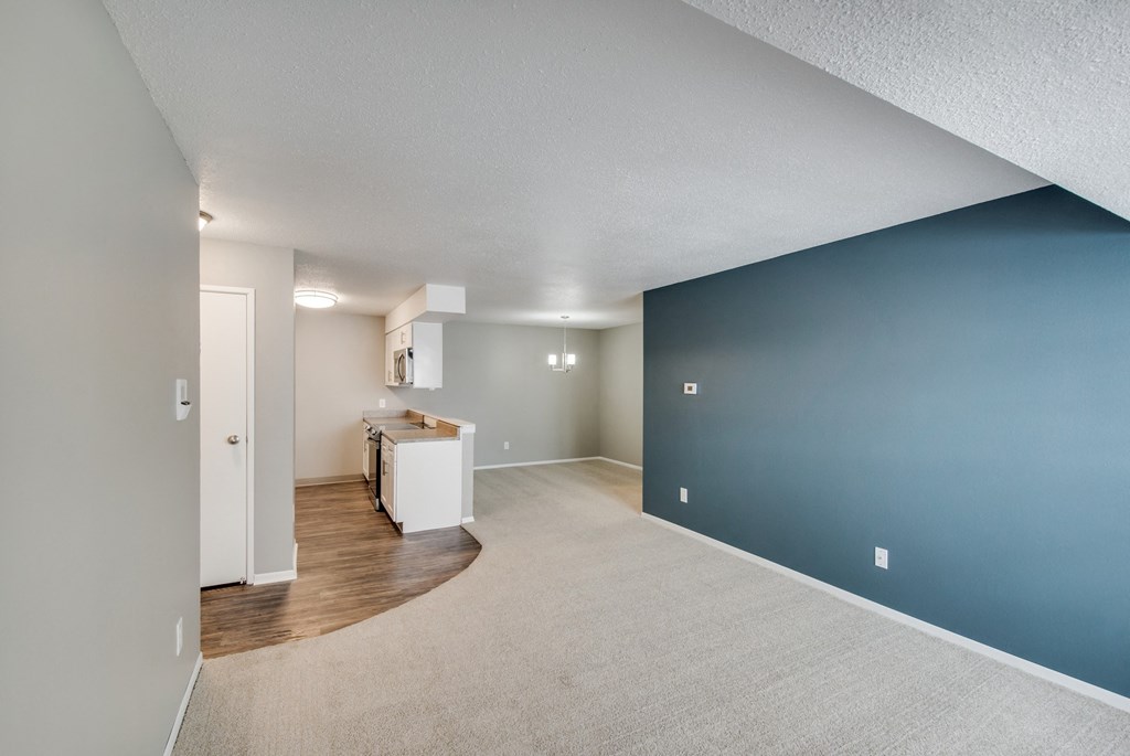 A kitchen area with a white countertop and a white refrigerator.