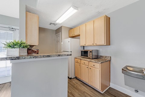 A kitchen with wooden cabinets and a granite countertop.