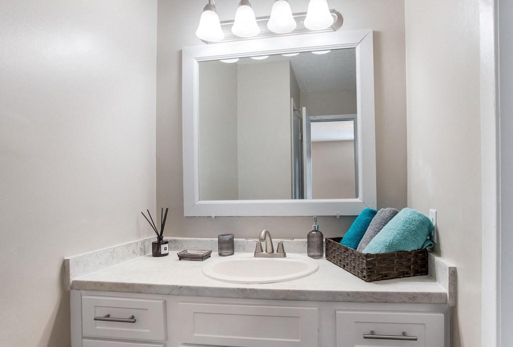 an empty bathroom with a sink and a mirror