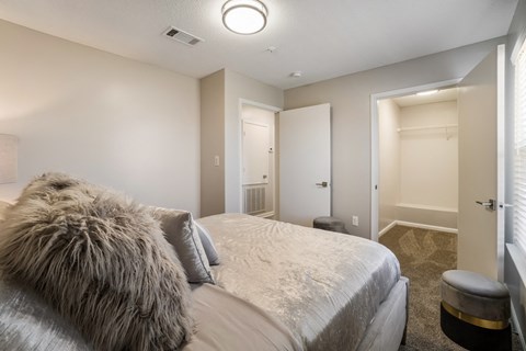 A bedroom with a large bed and a furry pillow.