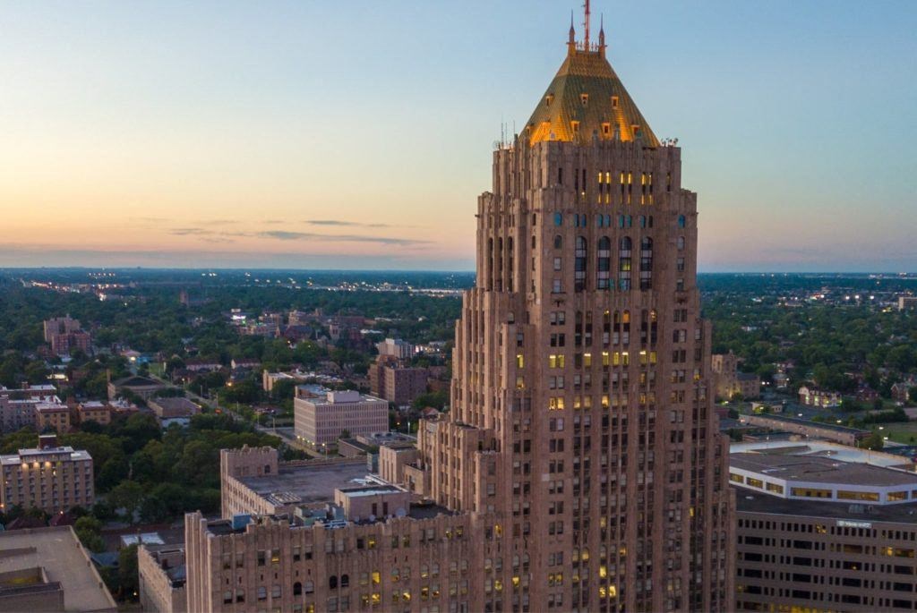 a tall building with a golden roof on top of it