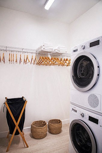 a laundry room with two washing machines and a dryer