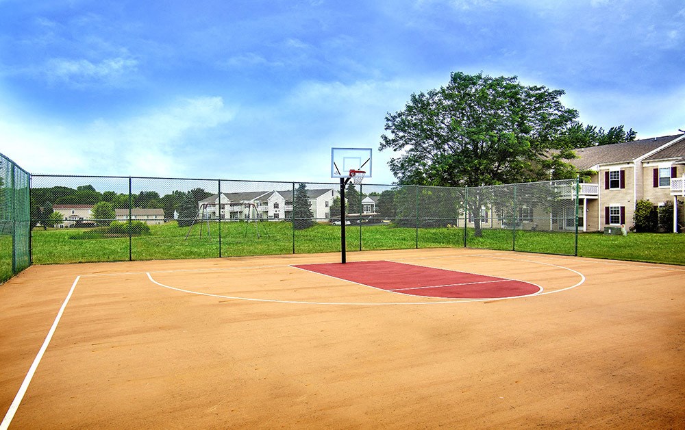 A basketball court with a red area in the middle.