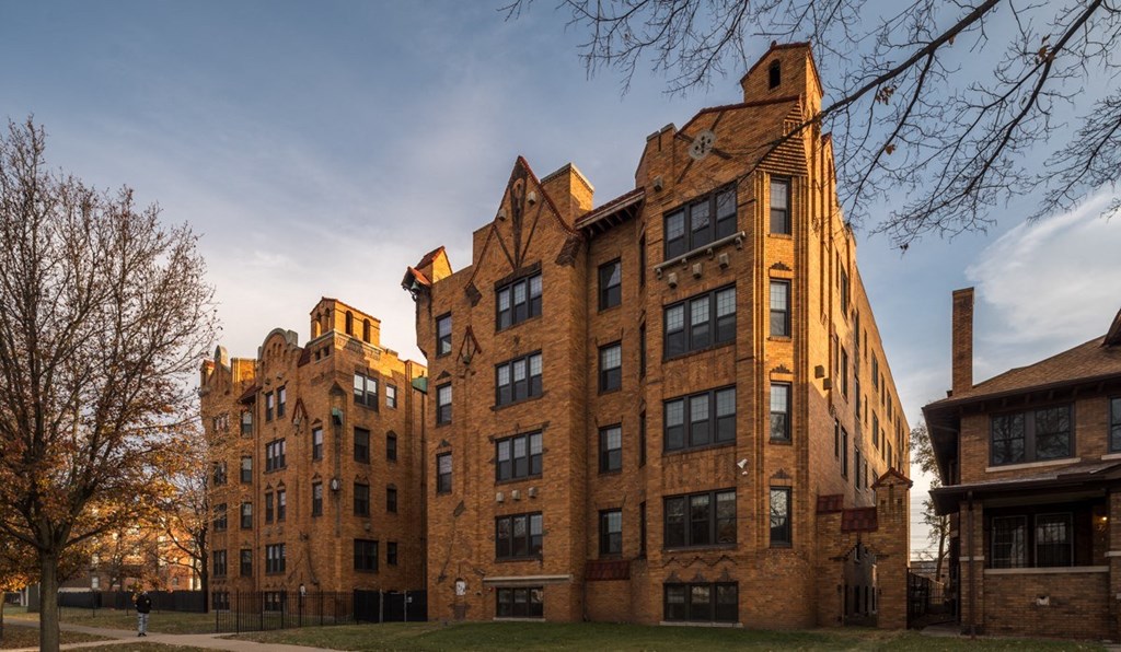 a large brick building with a blue sky in the background
