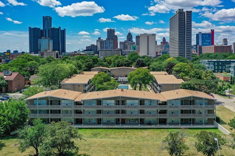 an aerial view of a building with a city in the background