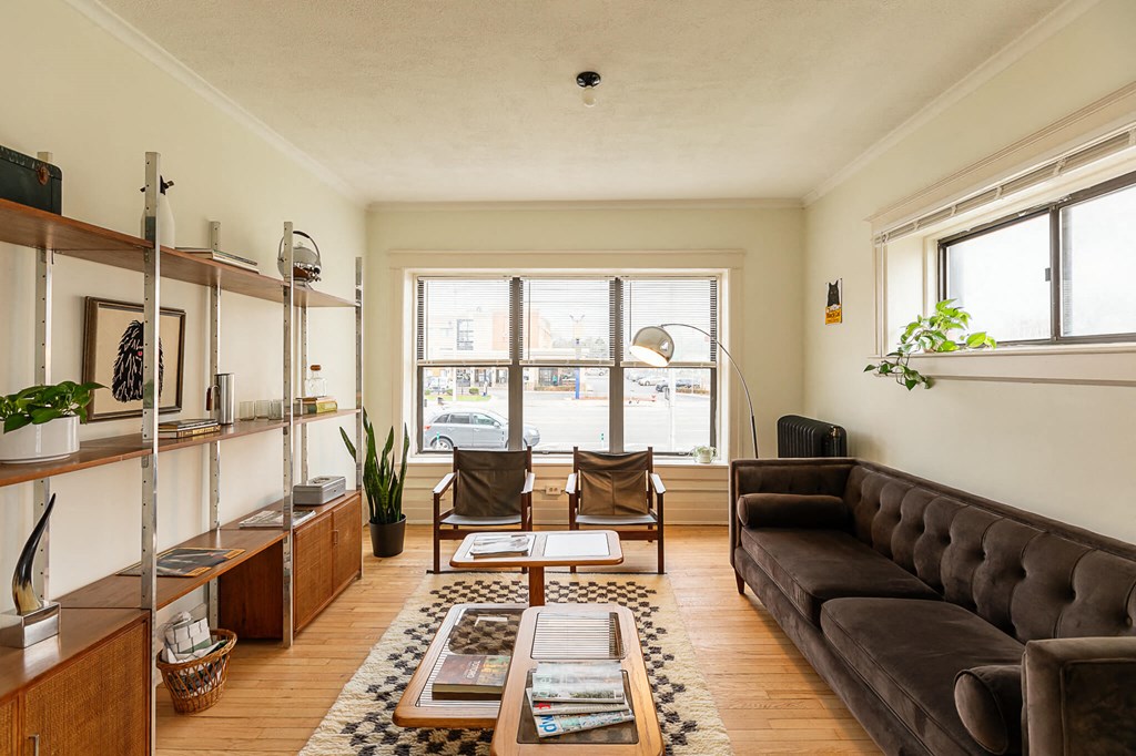 a living room with a leather couch and a large window