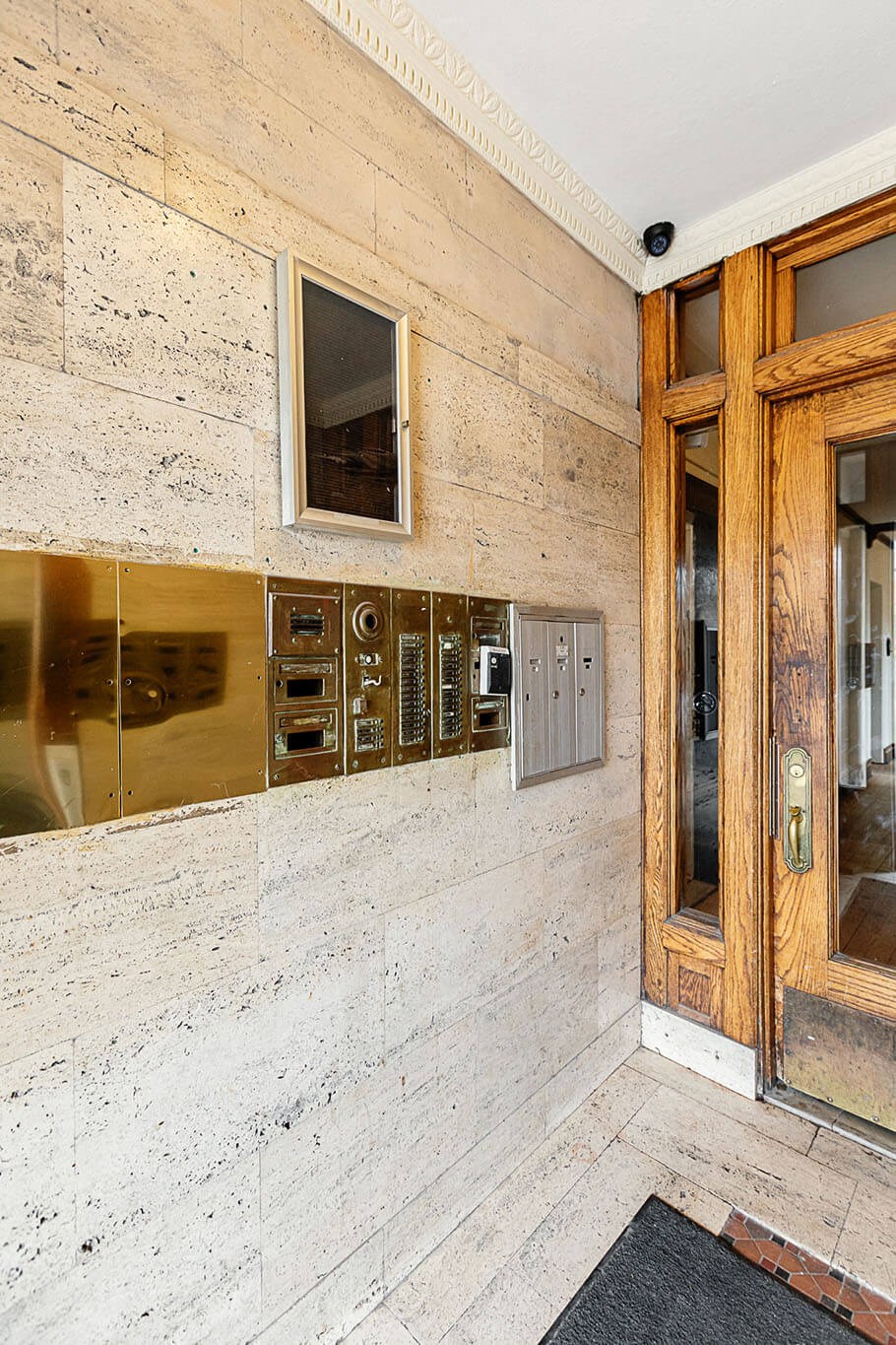 the lobby of a building with a large glass door and a window