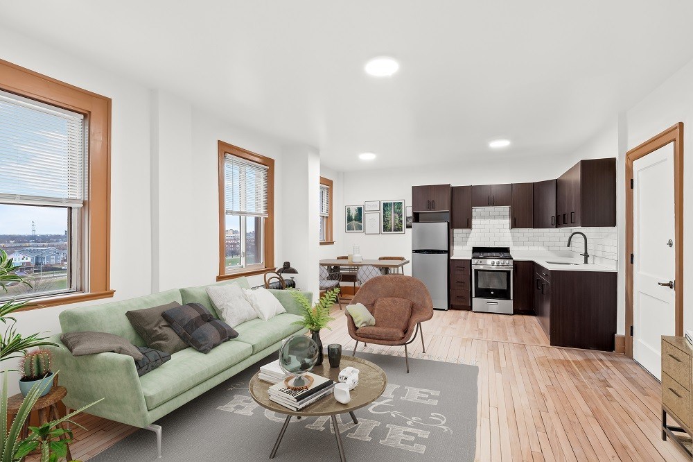 A living room with a green couch and a coffee table.