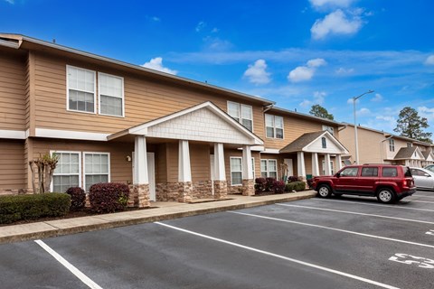Two story apartment buildings with parking area at Lifestyle at the Bay Apartments, Gulfport, 39503