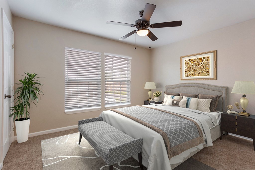 a bedroom with a large bed and a ceiling fan
