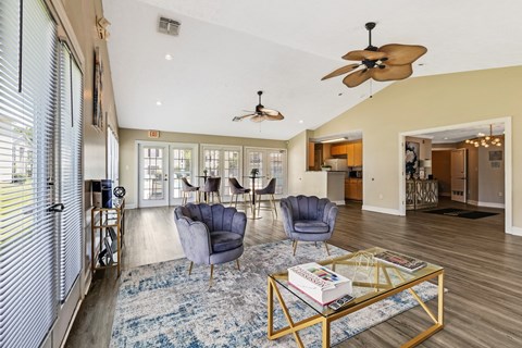 A living room with a blue rug and a coffee table.