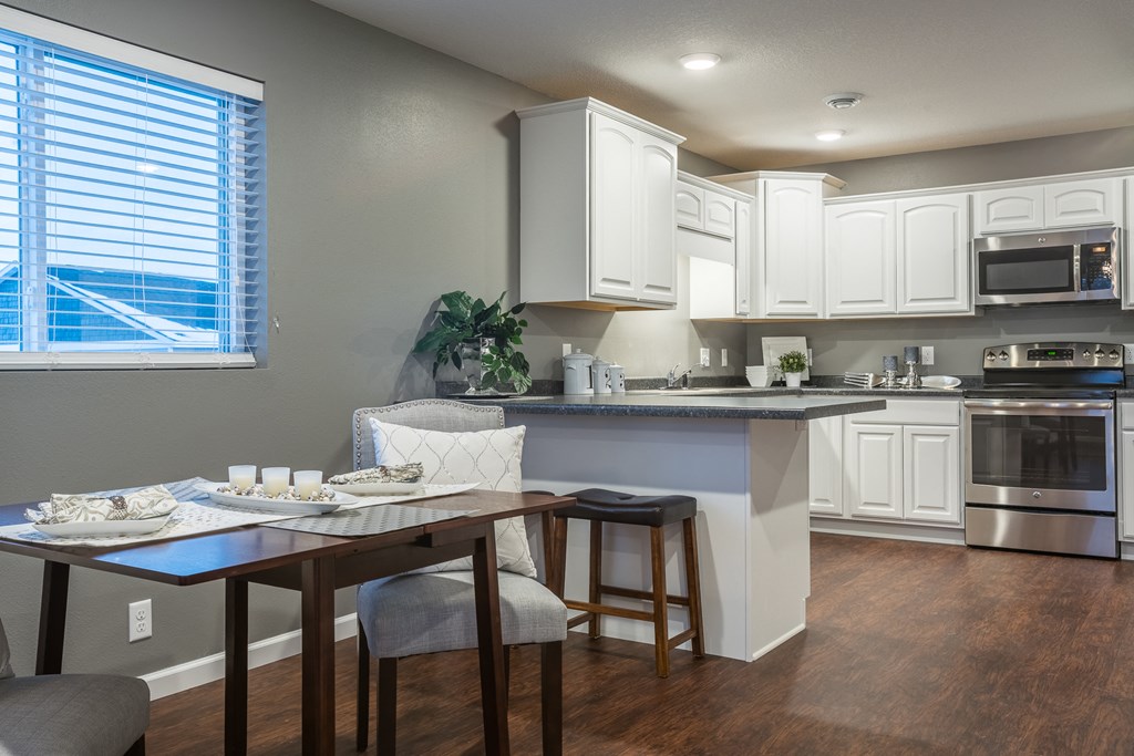 an open kitchen and dining area with a table and chairs