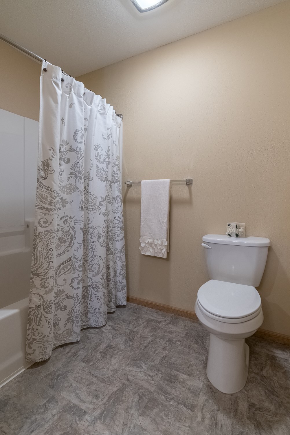 a bathroom with a toilet and a shower curtain