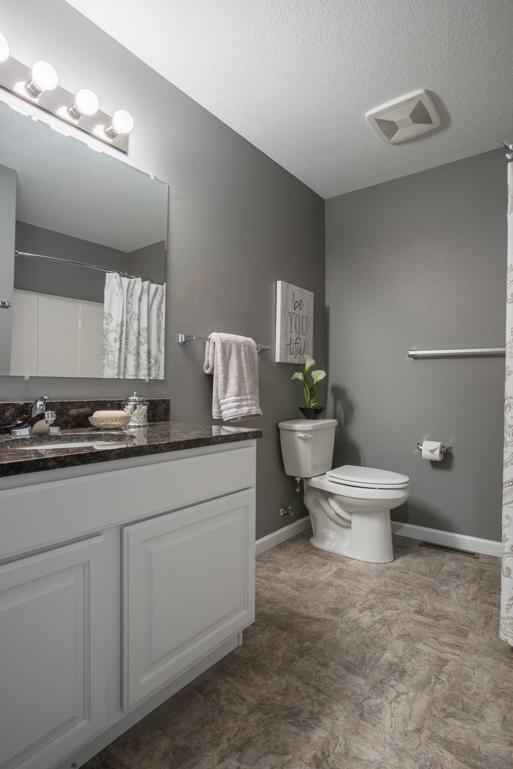 a bathroom with a toilet and a sink and a mirror