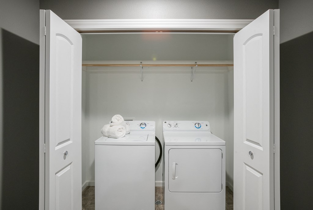 a laundry room with two washes and a dryer