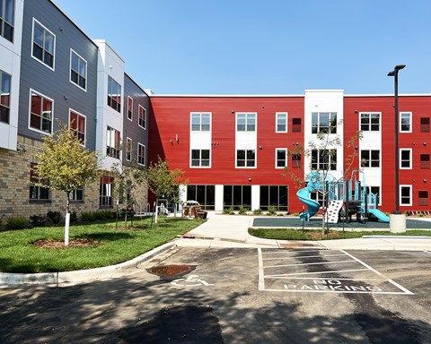 A red and white building with a playground in front.