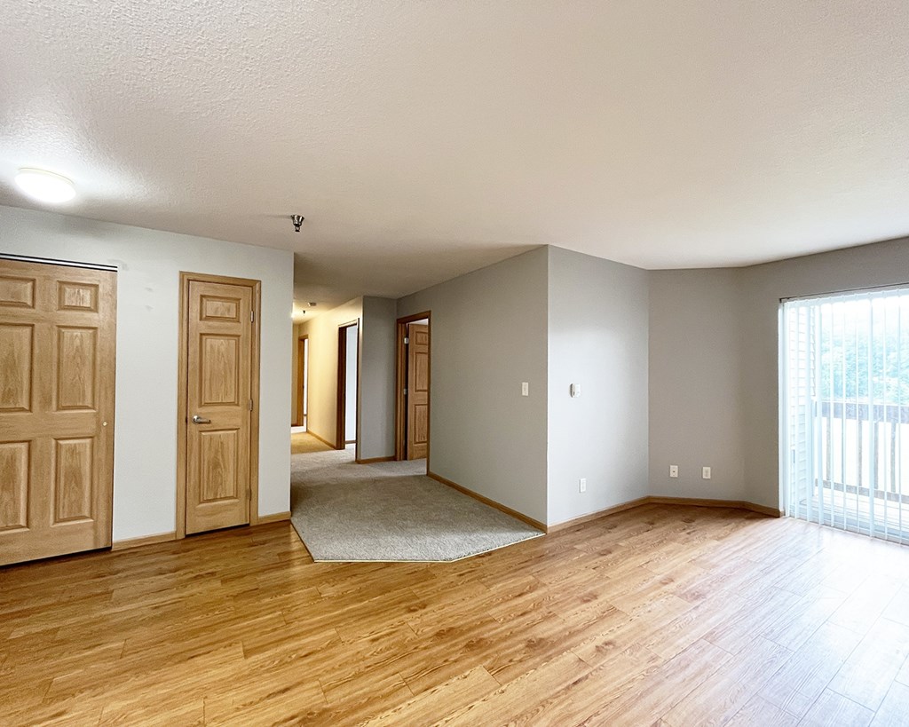 A room with wooden floors and white walls.