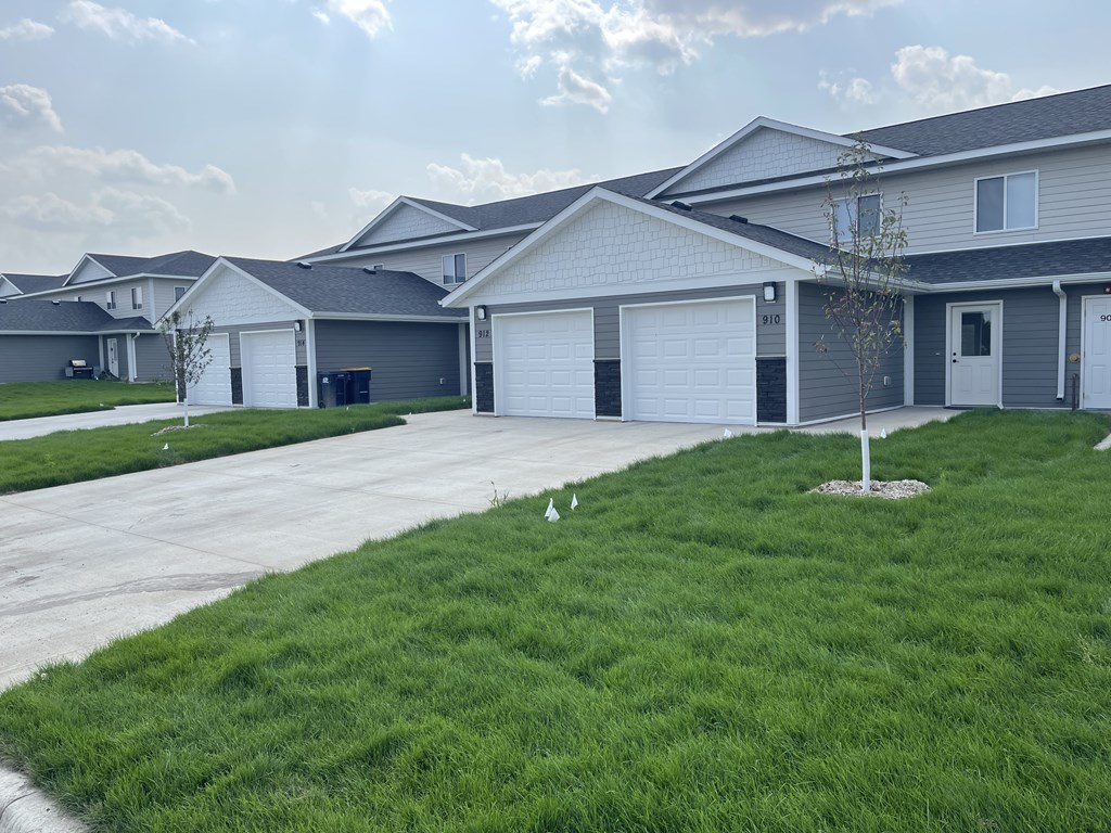 A residential area with houses and a tree.