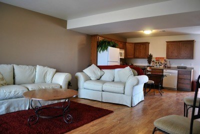 A living room with a white couch and a coffee table.