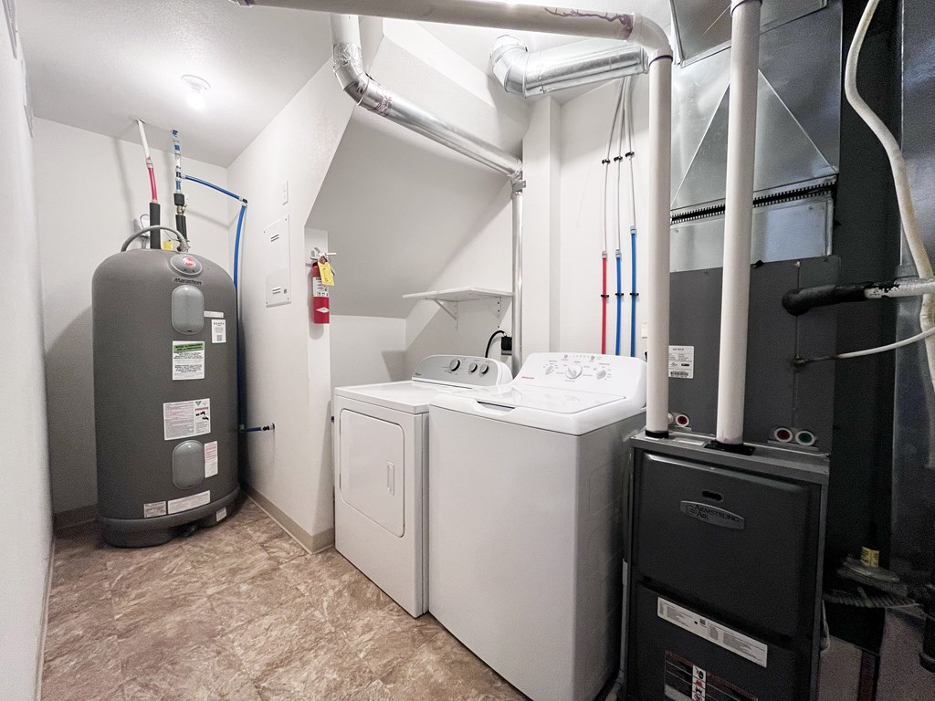 A water heater and a washing machine in a utility room.