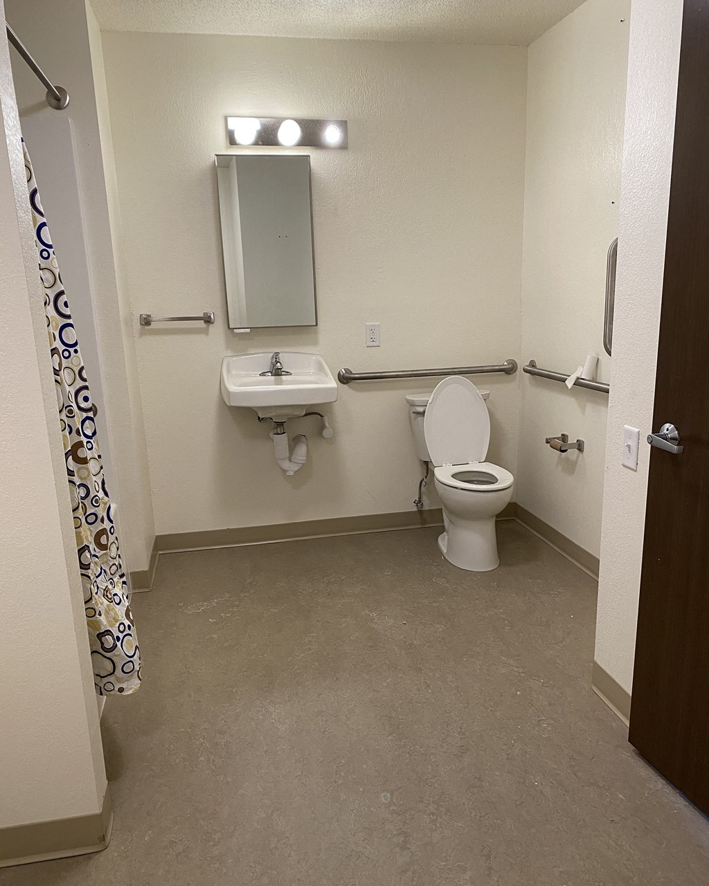 a bathroom with a toilet and a sink and a mirror