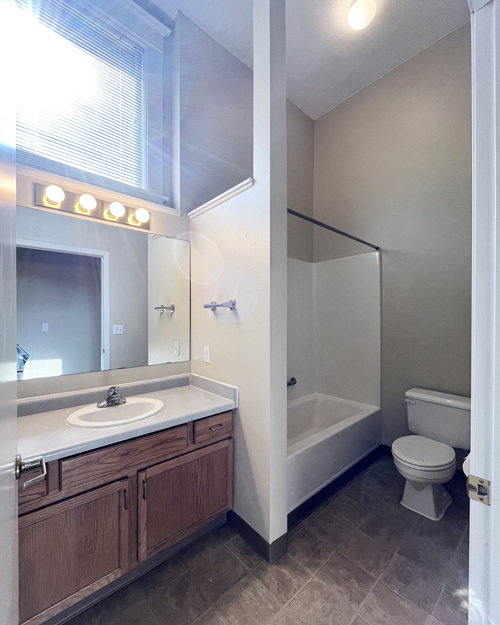 A bathroom with a sink, toilet, and bathtub.